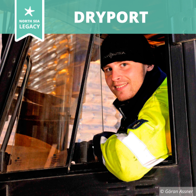 A smiling man in a truck.