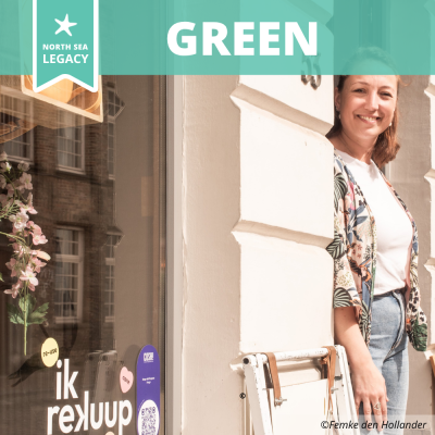 Smiling lady in front of her circular shop.