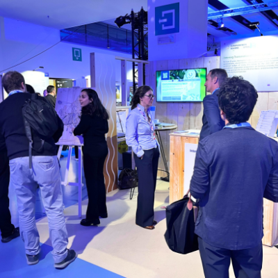 People standing and chatting at stand