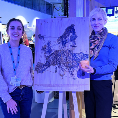 Three people standing by a map