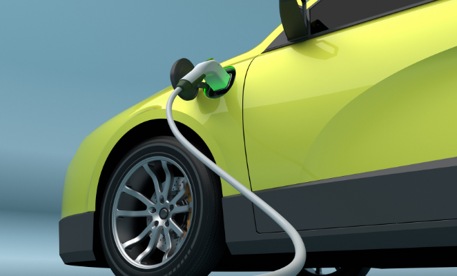 A green electric car being charged.