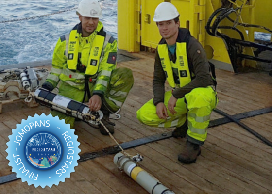 2 people working on measuring device on a boat in the sea