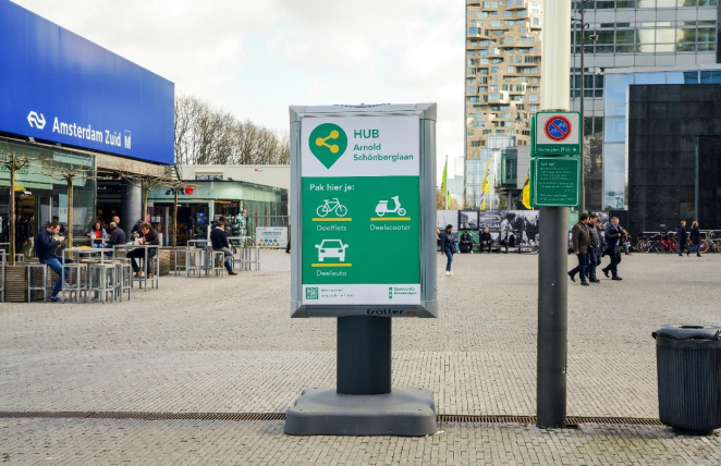 A hub board with the identity situated next  to a train station