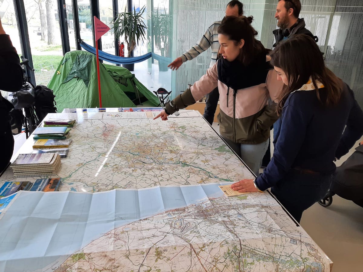 Attendees at a traveller meeting at the Sustainable Mobility House in Lille. Here, people can share their experiences of travelling by bike, foot, or train to inspire future visitors. 