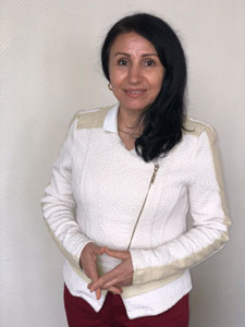 portrait photo of a lady wearing a white jacket.