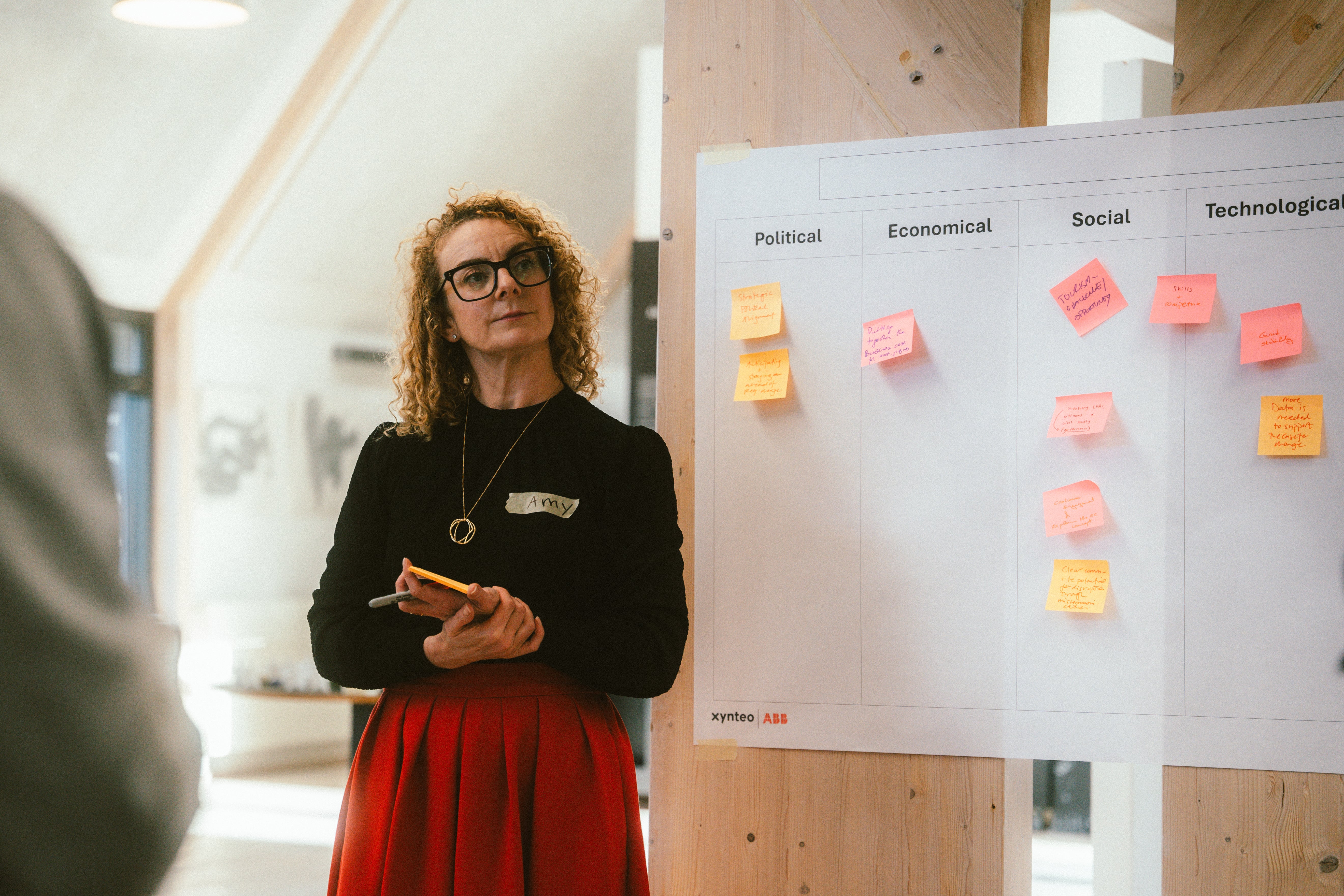 woman standing next to whiteboard