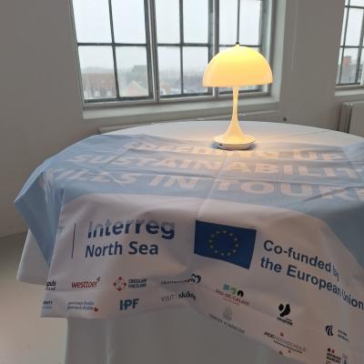 Our new 3ST flag with the Interreg logo and the logos of all the partners on display.