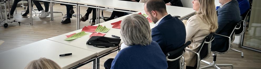 People sitting at connected tables