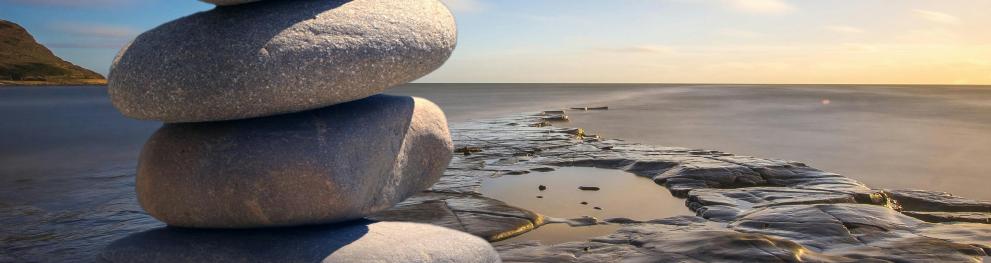 Stack of stones on a beach with seaview