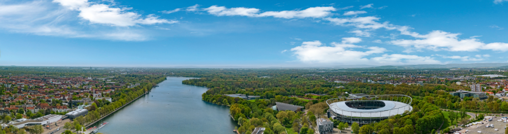 Aerial view of Hannover and the Masch Lake surrounded by green trees.