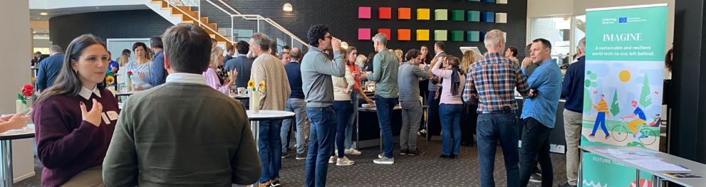 People networking in a lobby during a major event. 